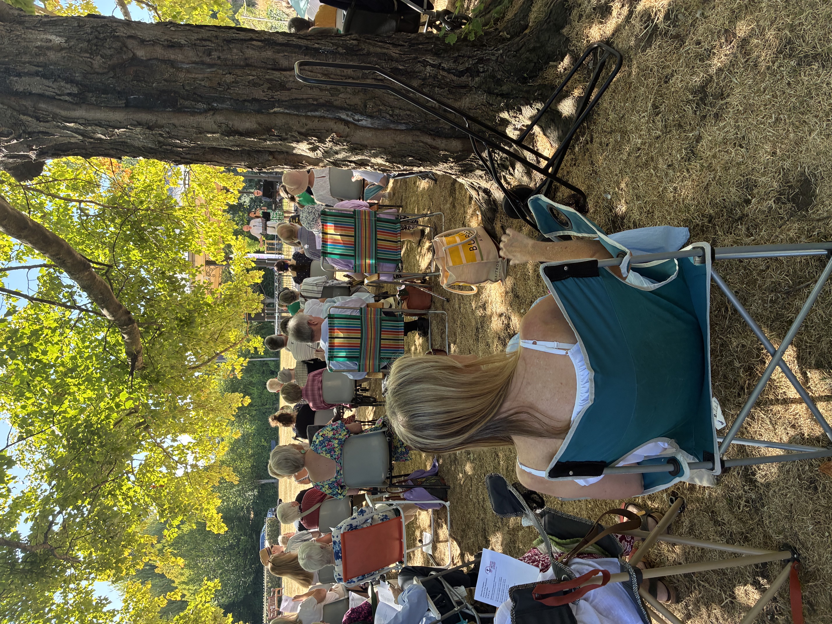 Worshippers seated in the shade for the Churches Together Bandstand Service