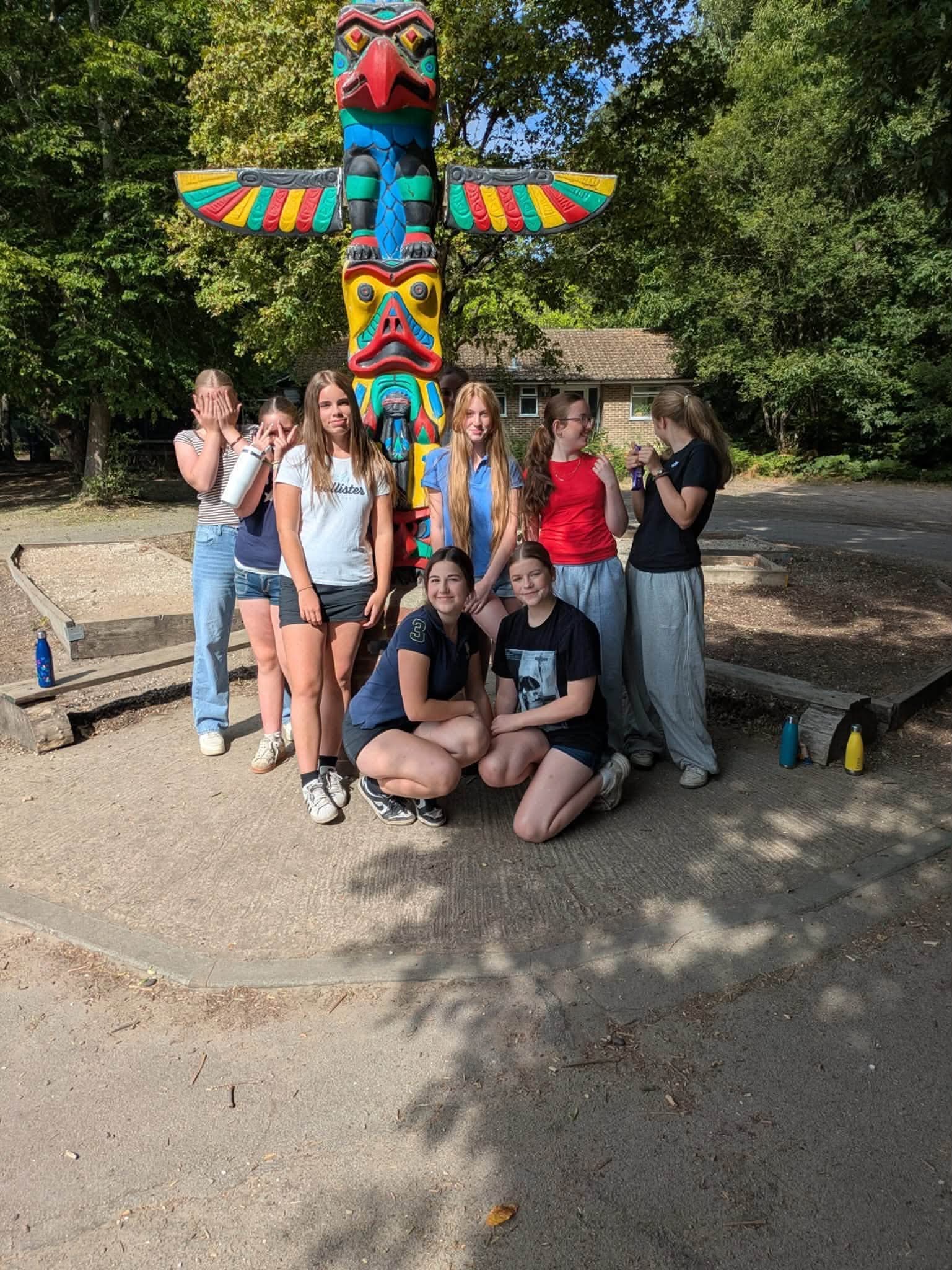 Young people together beside a colourful totem pole during Summer Activities Week 2026